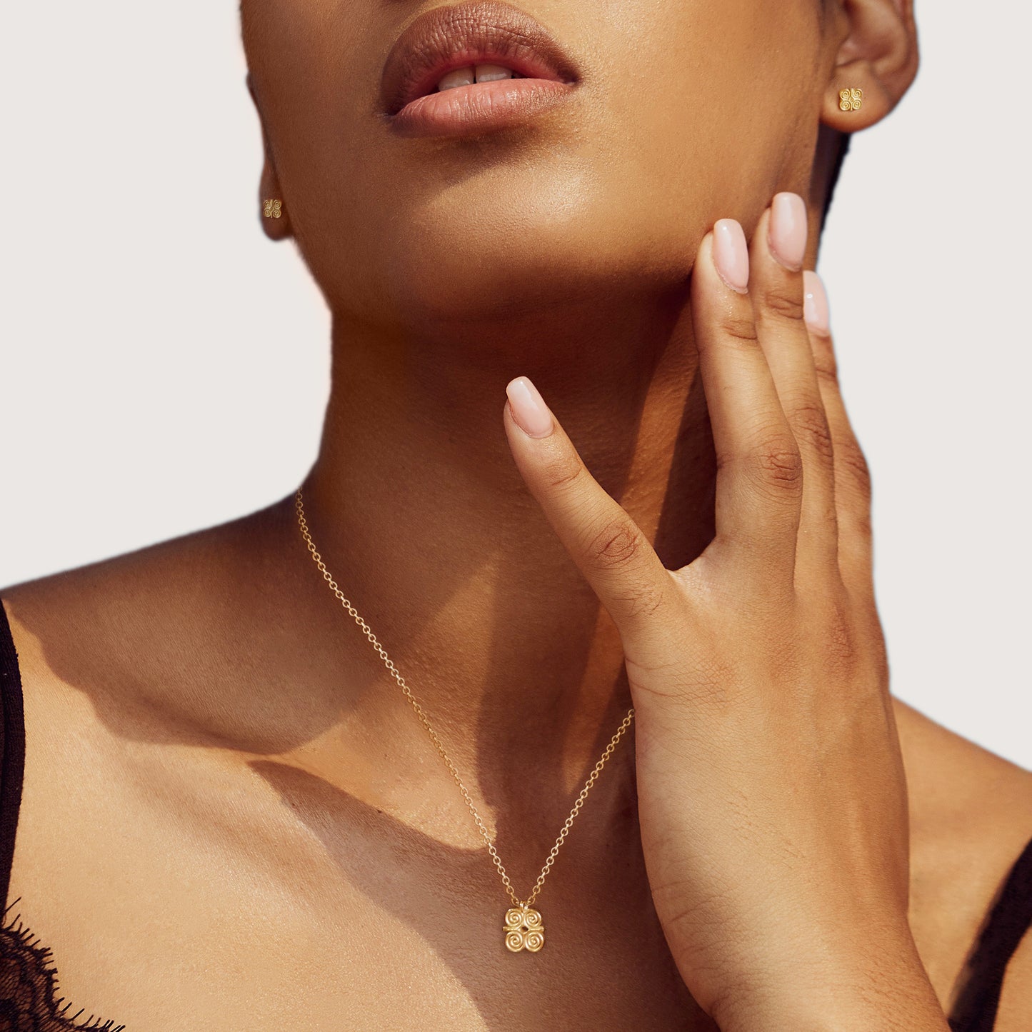 Adinkra Collection Dwennimmen Necklace in polished 14ct yellow gold, featuring a 10mm pendant symbolizing humility and strength ('Ram's Horns'). Perfect for everyday wear, alone or layered. Sold on a 16-inch chain.