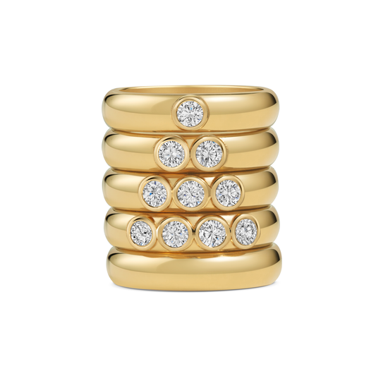 Seven Aunties Collection. Nia Stacking Rings, Seven Aunties Collection  - 9ct yellow gold, 0.10ct–0.41ct SI1 diamonds, 4.5mm band. Handcrafted in London.